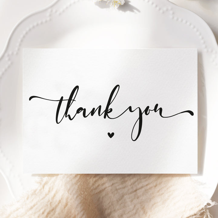 a white plate topped with a card that says thank you