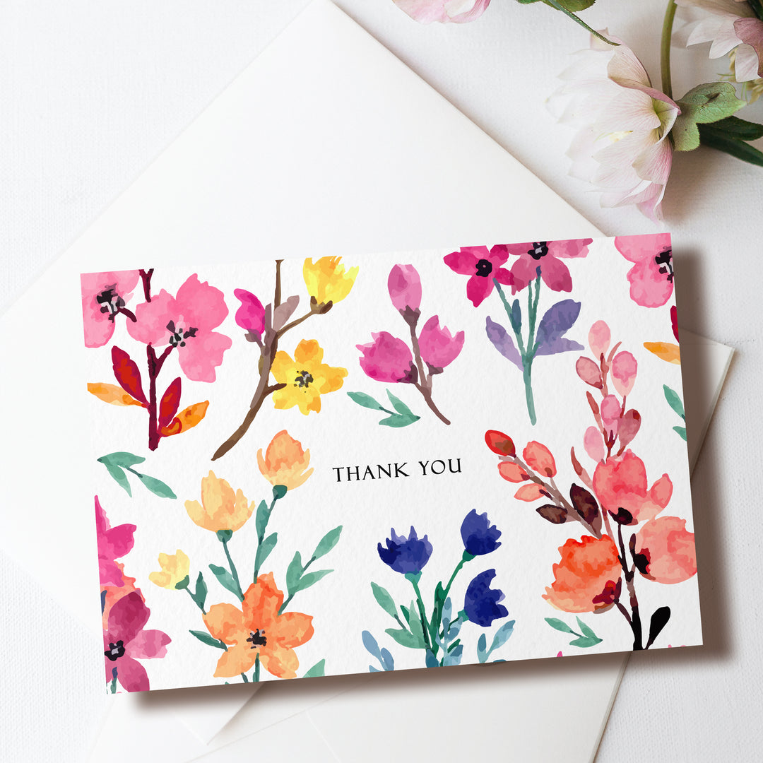 a thank you card with watercolor flowers on it