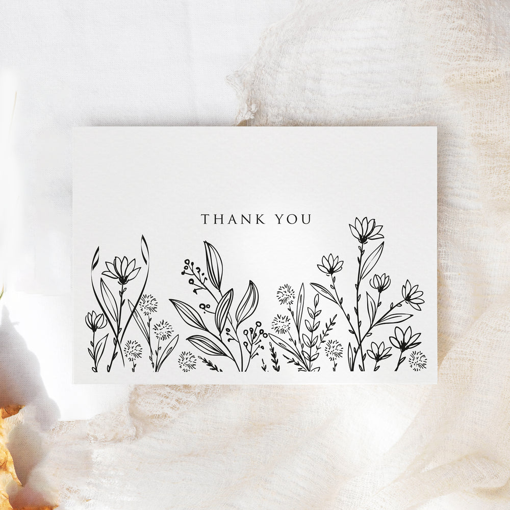 a thank you card sitting on top of a table