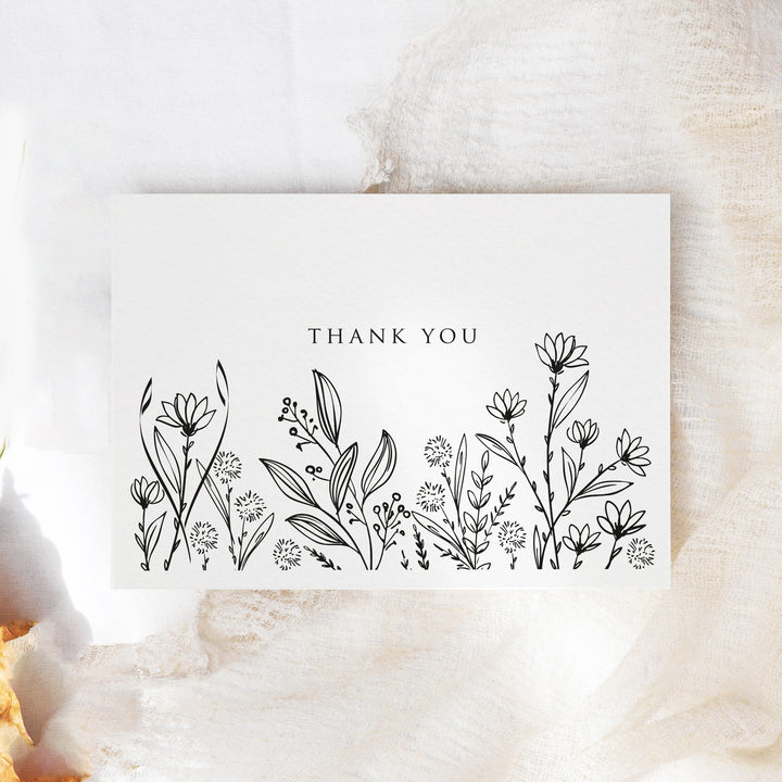 a thank you card sitting on top of a table