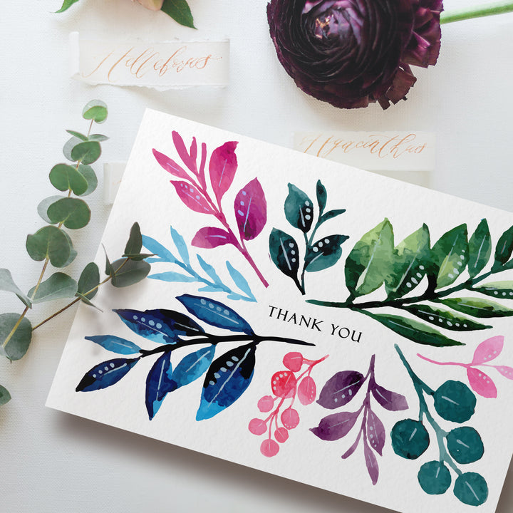 a thank card with watercolor leaves on it