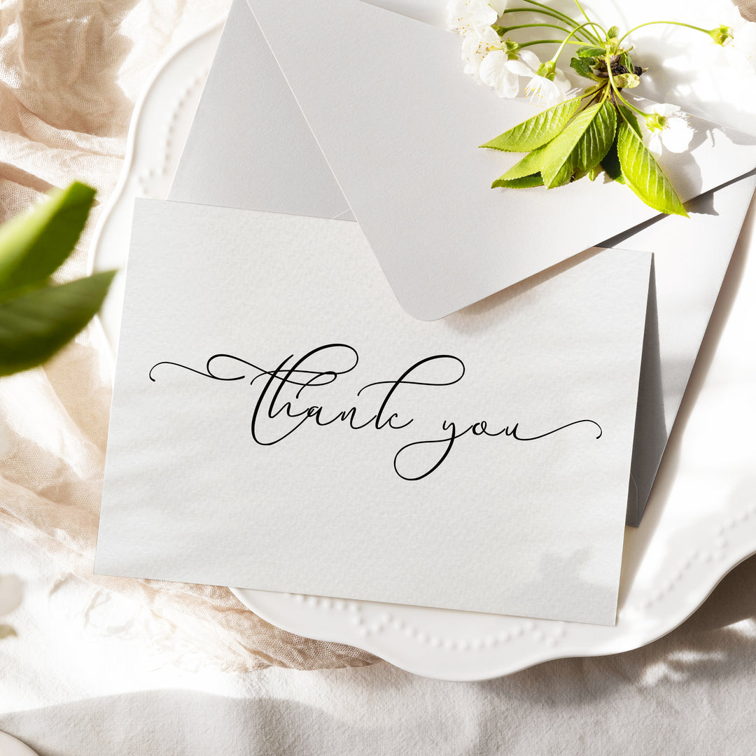 a thank you note sitting on top of a white plate