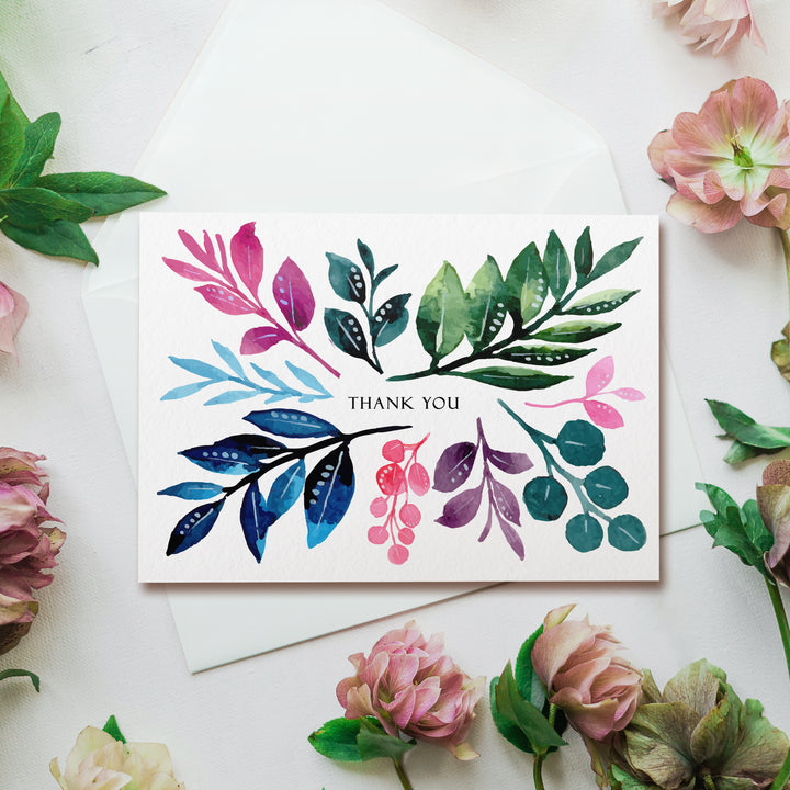 a thank you card surrounded by flowers and leaves