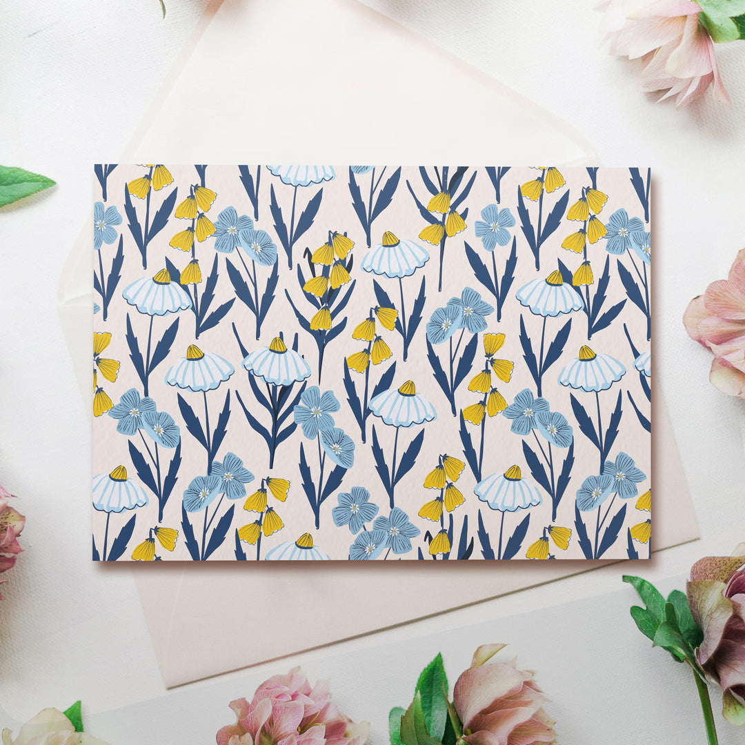 a greeting card with a blue and yellow floral pattern