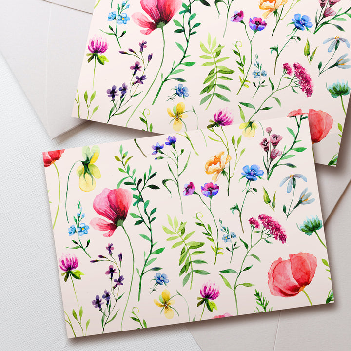 two cards with watercolor flowers on them