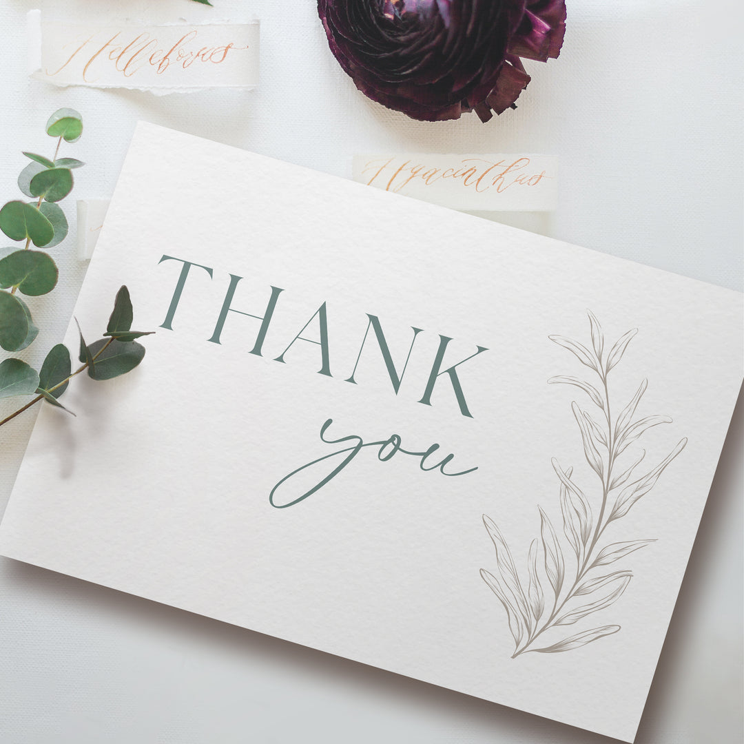 a thank you card sitting on top of a table