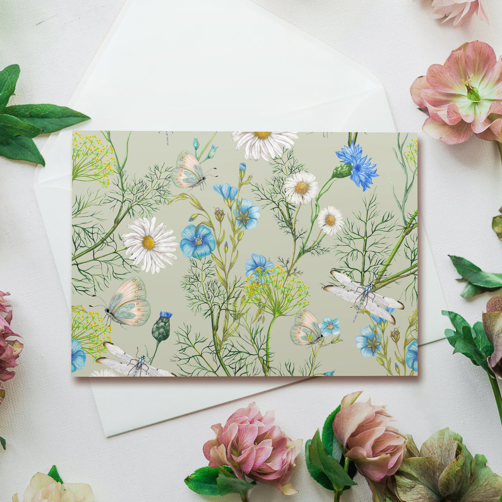 a card with flowers and a bird on it