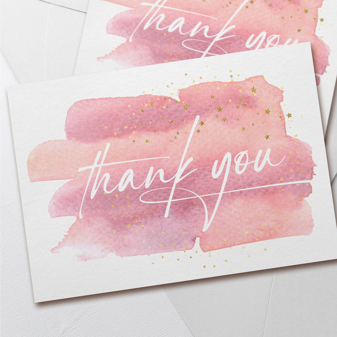 two thank you cards with pink and gold ink