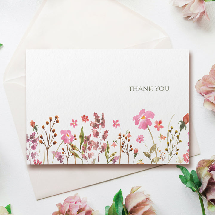 a thank you card with pink flowers and greenery