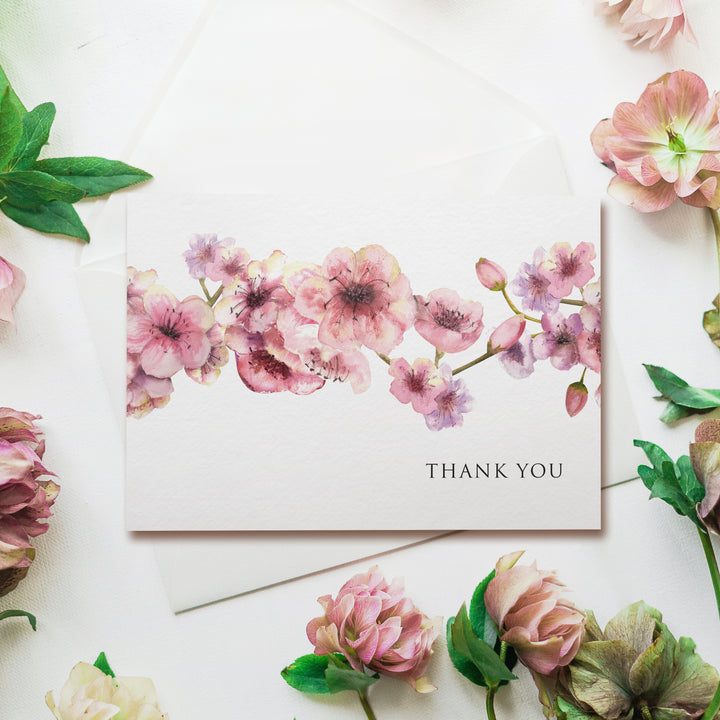 a thank you card with pink flowers and green leaves