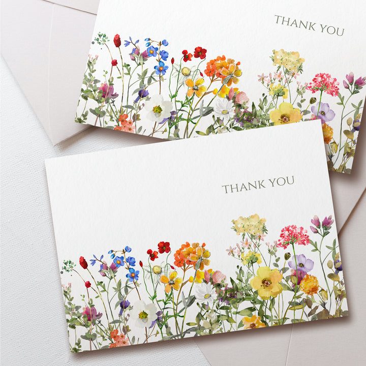 two thank cards with colorful flowers on them