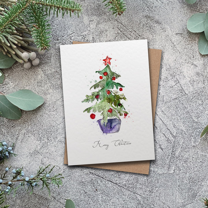 a card with a watercolor christmas tree on it