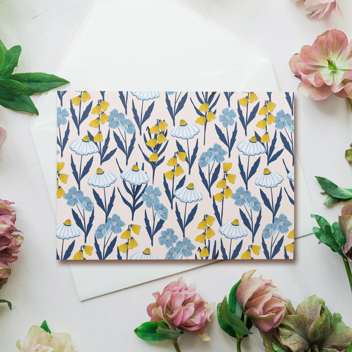 a card with blue and yellow flowers on it