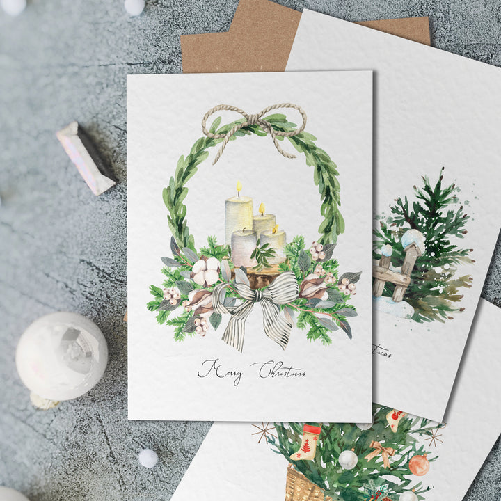 three christmas cards with a candle and wreath on them