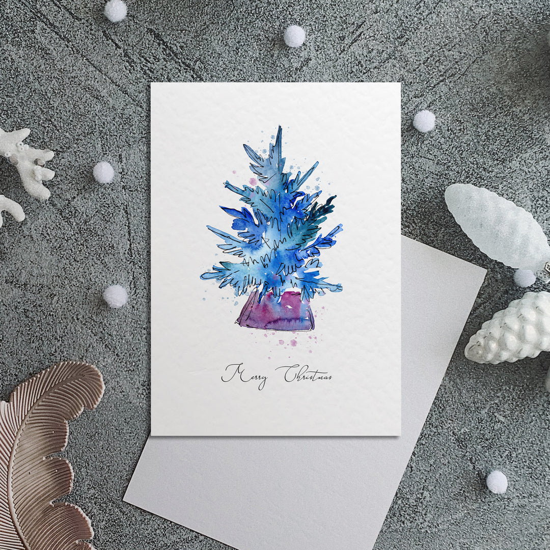 a card with a blue christmas tree on it