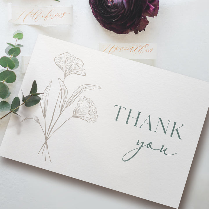 a thank you card with flowers and greenery