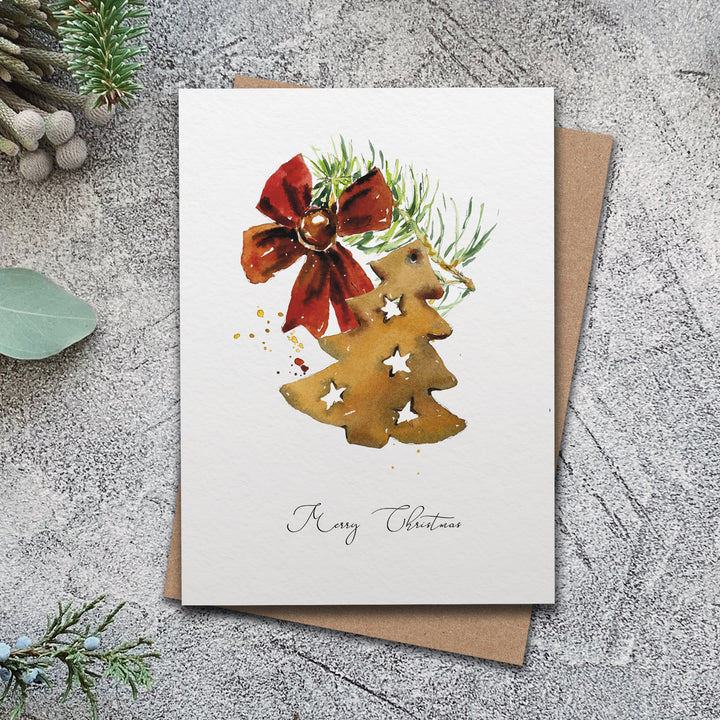 a card with a christmas tree and a bow