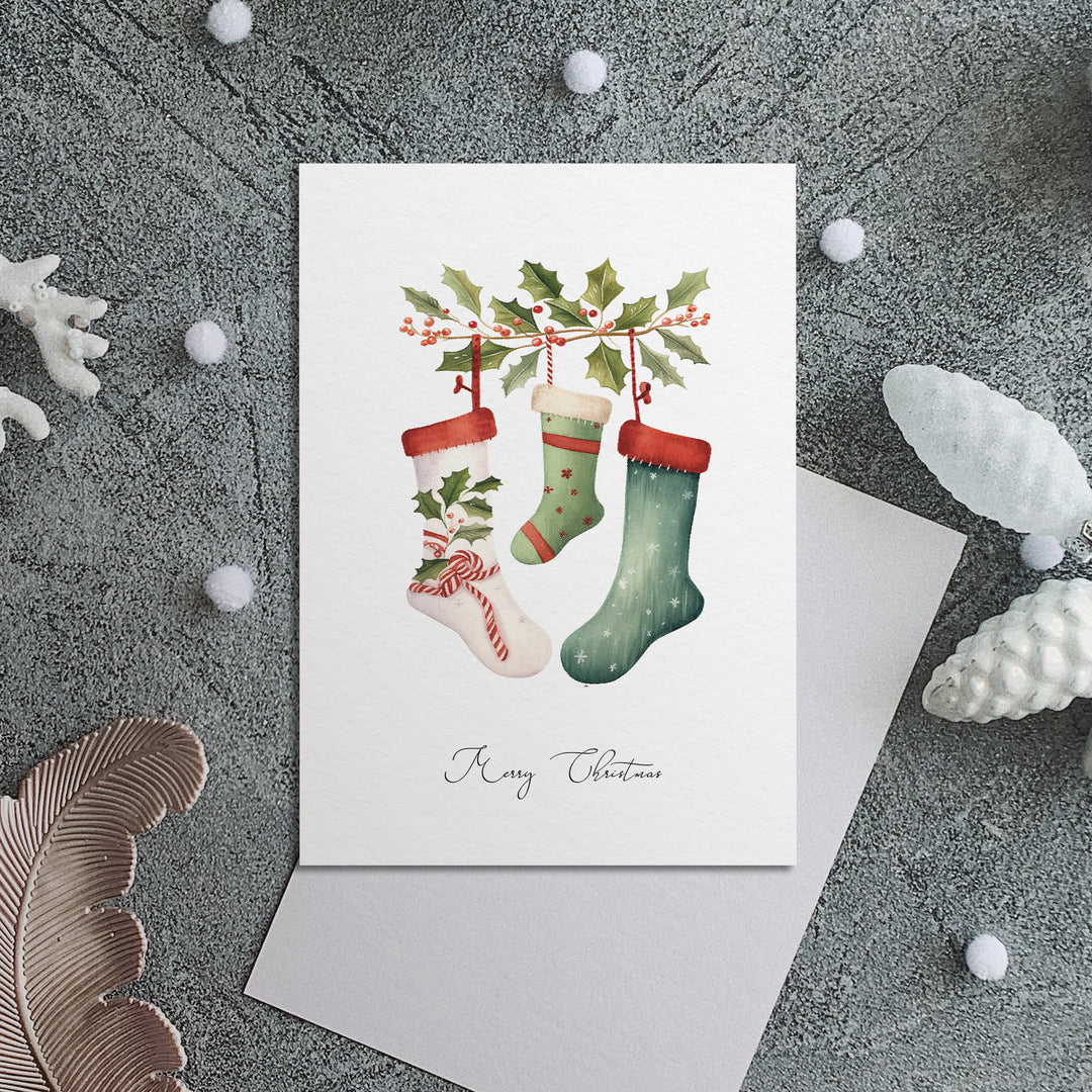 a christmas card with stockings and holly on it