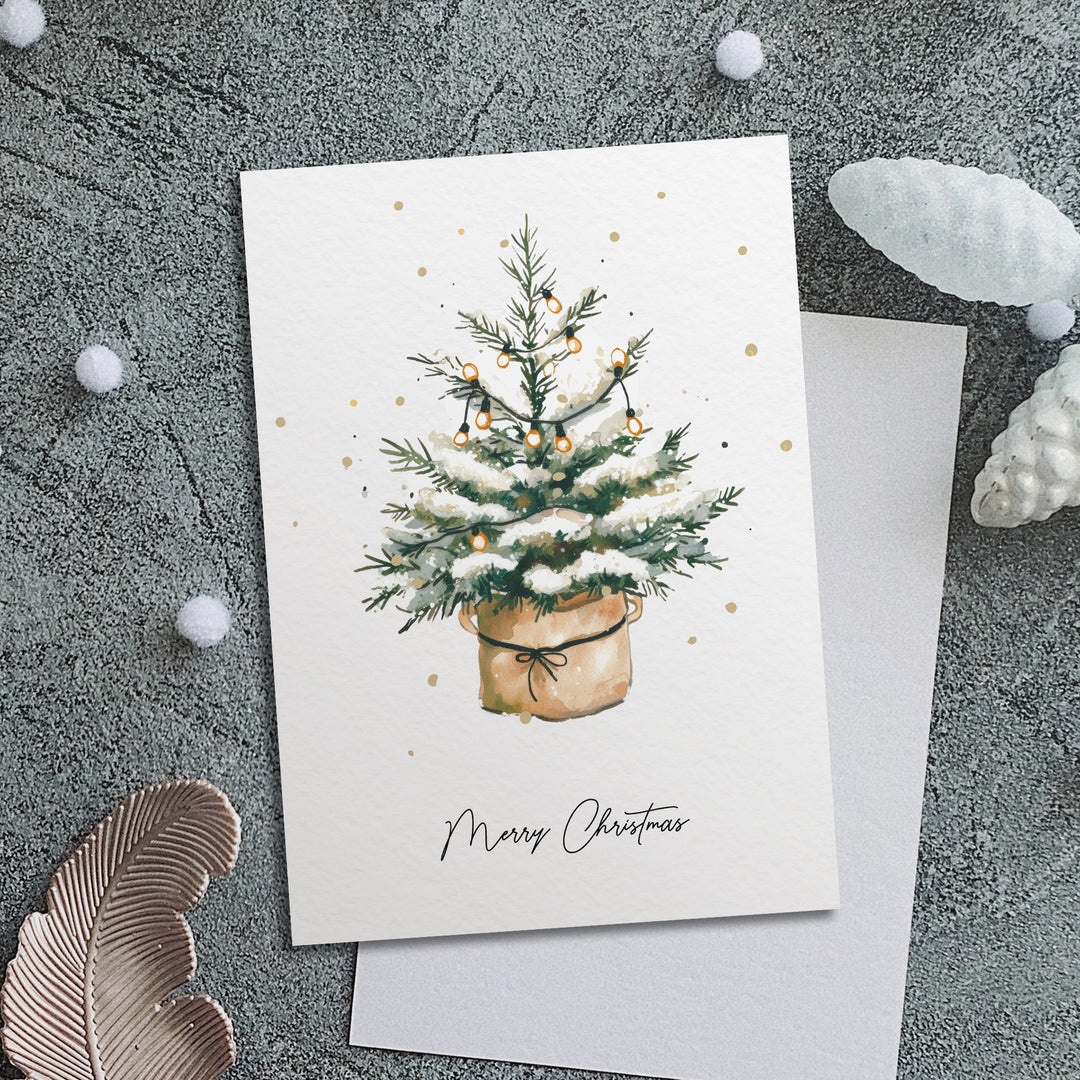 a card with a christmas tree in a pot