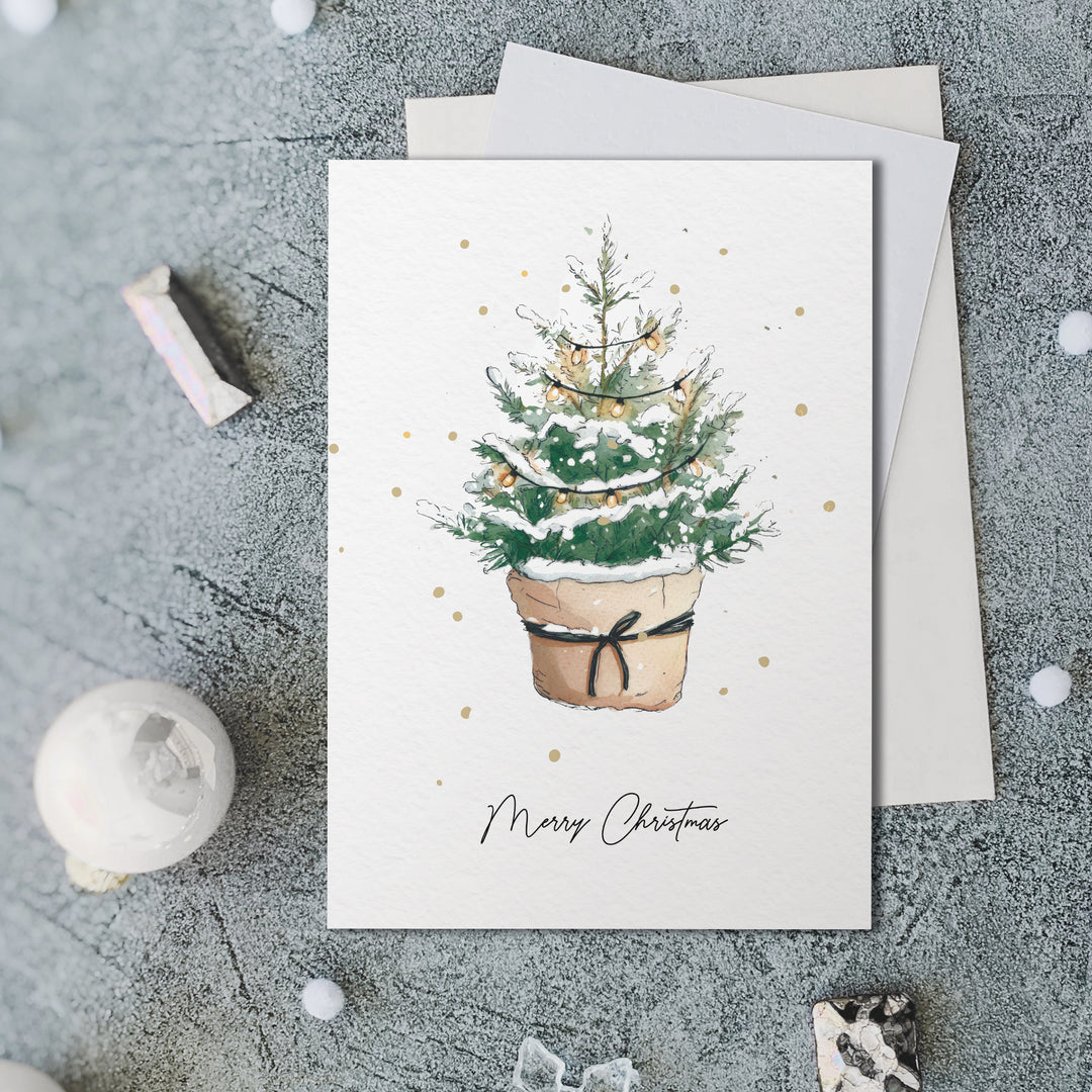 a card with a christmas tree in a pot