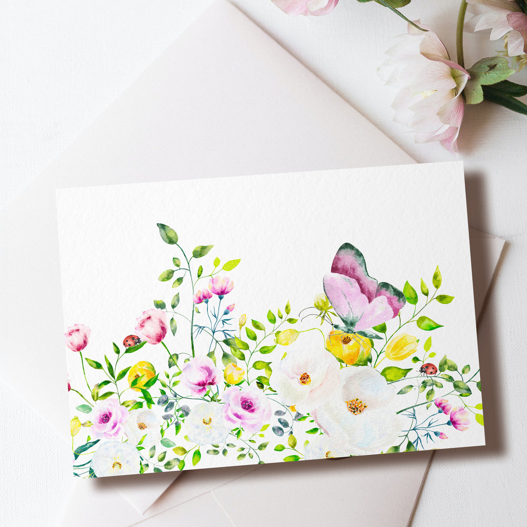 a card with a watercolor painting of flowers on it