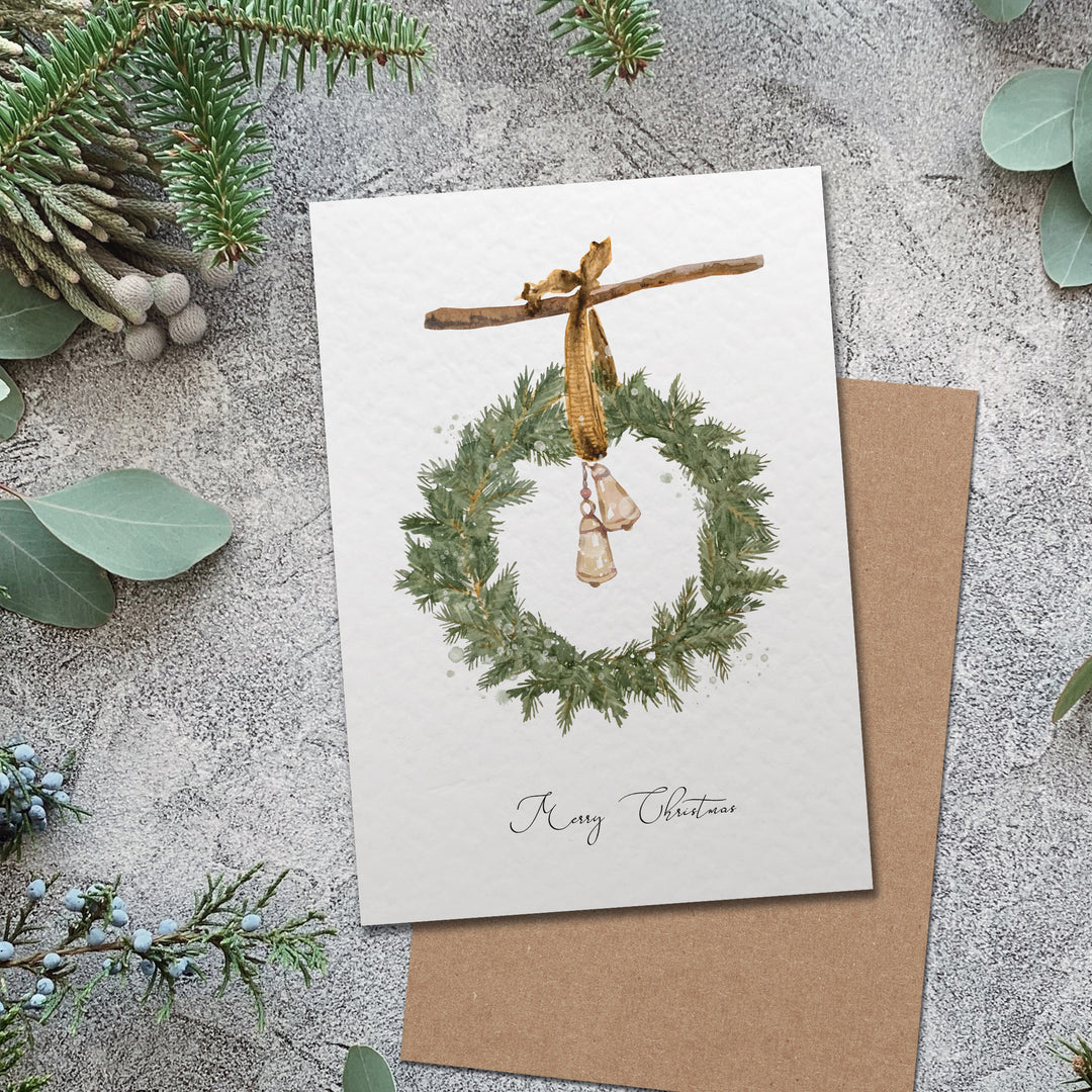 a card with a wreath and bells on it