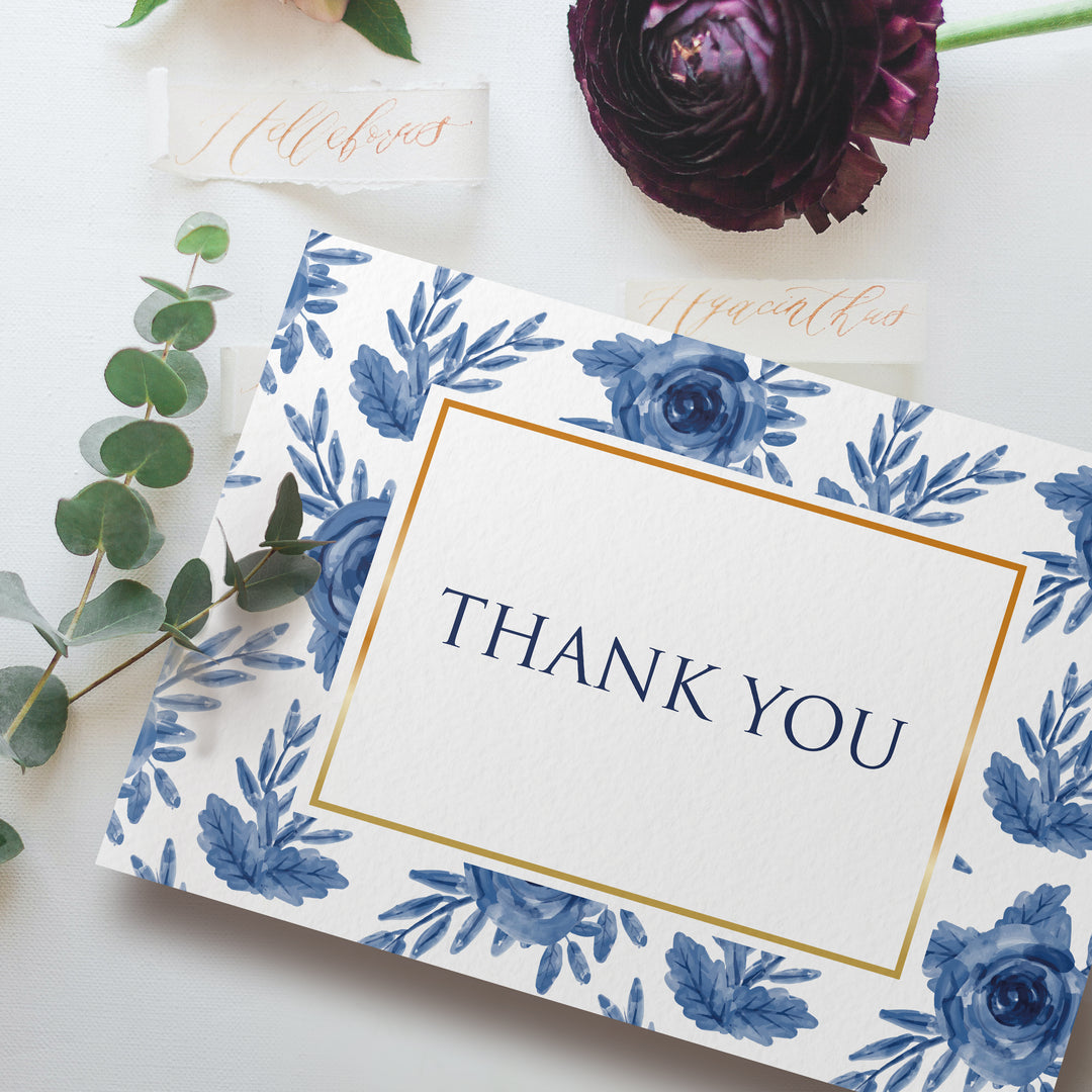 a thank you card with blue flowers and greenery