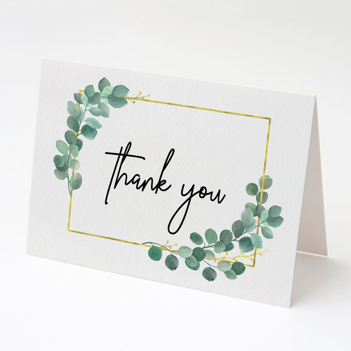 a thank card with green leaves and a gold frame