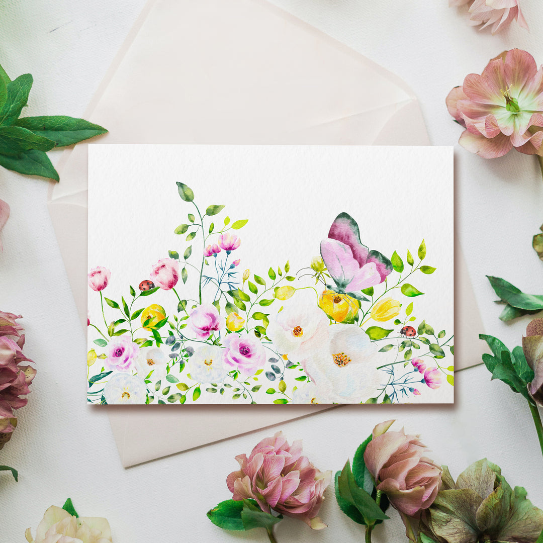 a greeting card with a watercolor painting of flowers