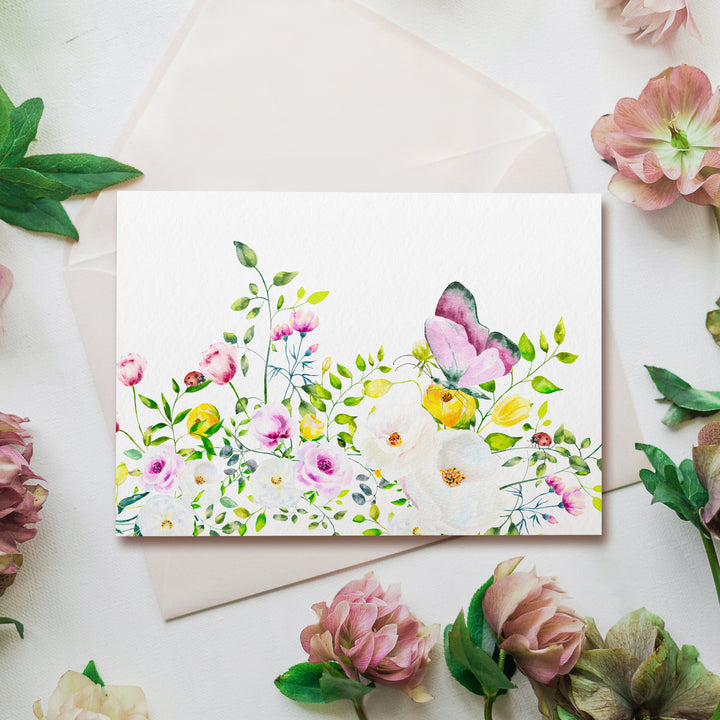 a greeting card with a watercolor painting of flowers