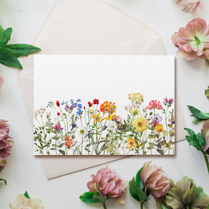 a greeting card featuring a field of wildflowers