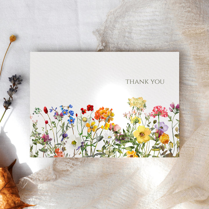 a thank card with colorful flowers on it