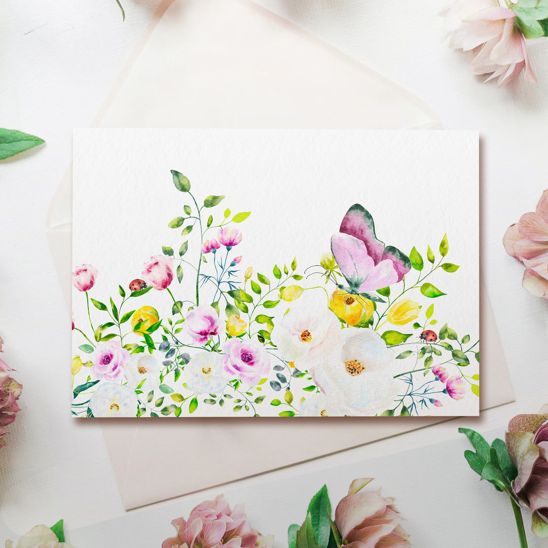 a card with a watercolor painting of flowers on it