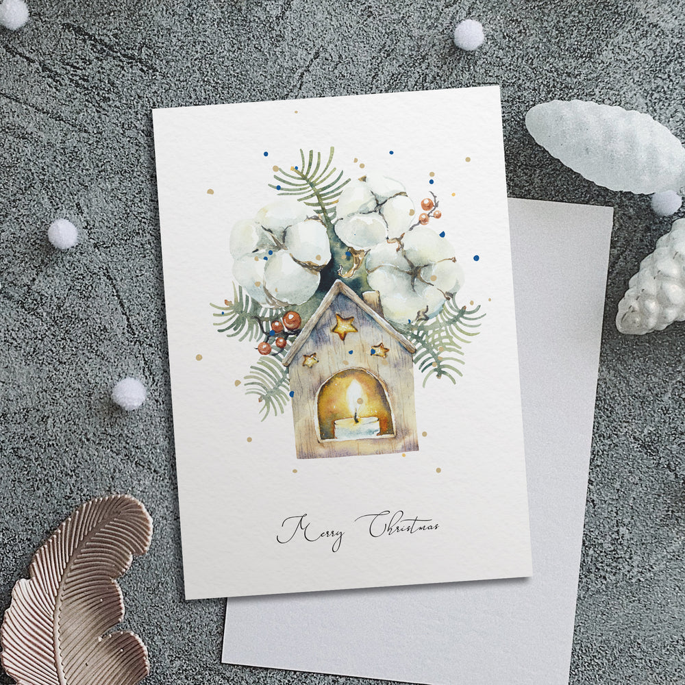 a card with a picture of a house and a candle