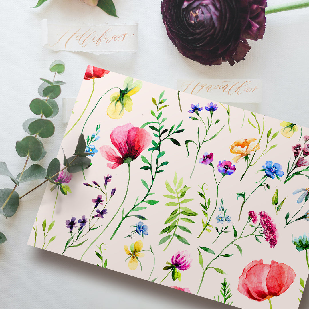 a card with watercolor flowers on it