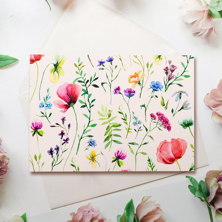 a card with watercolor flowers on it