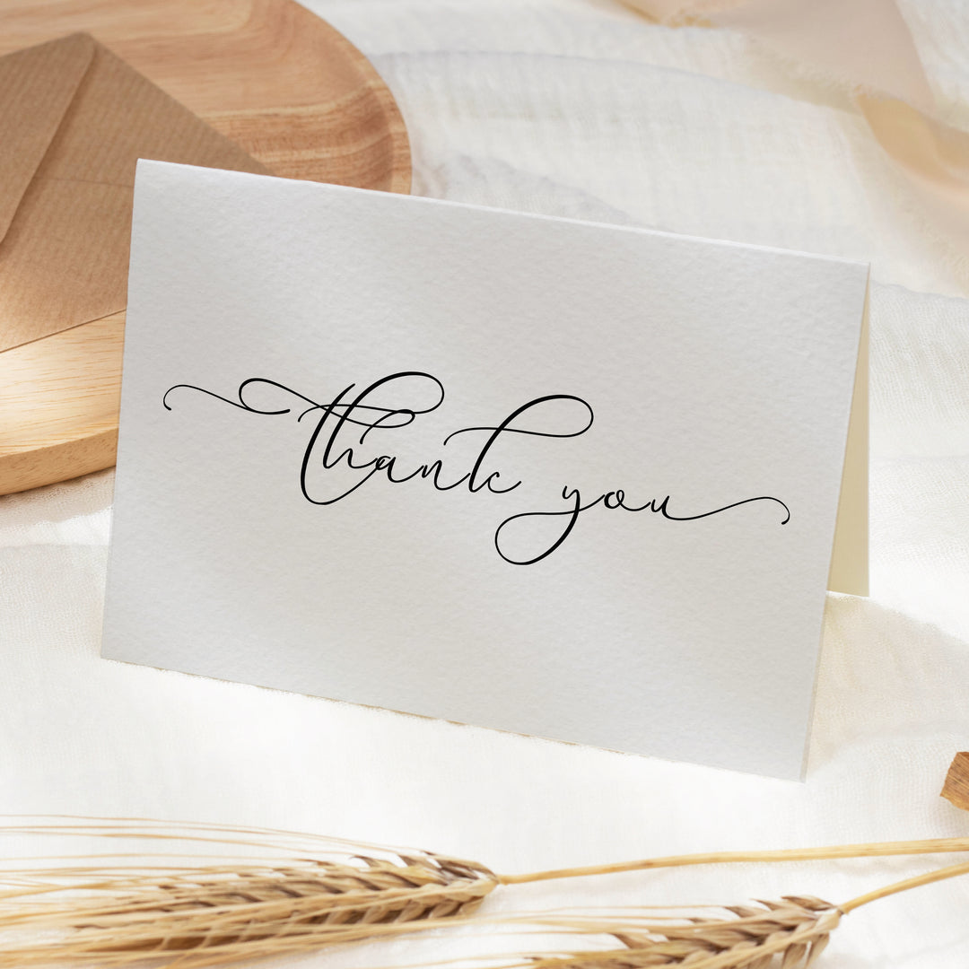 a thank you card sitting on top of a table