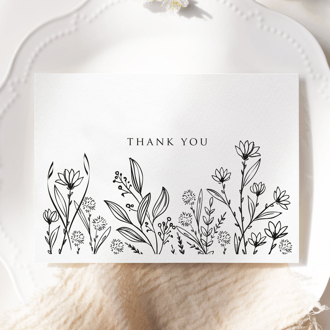 a thank you card with a black and white floral design