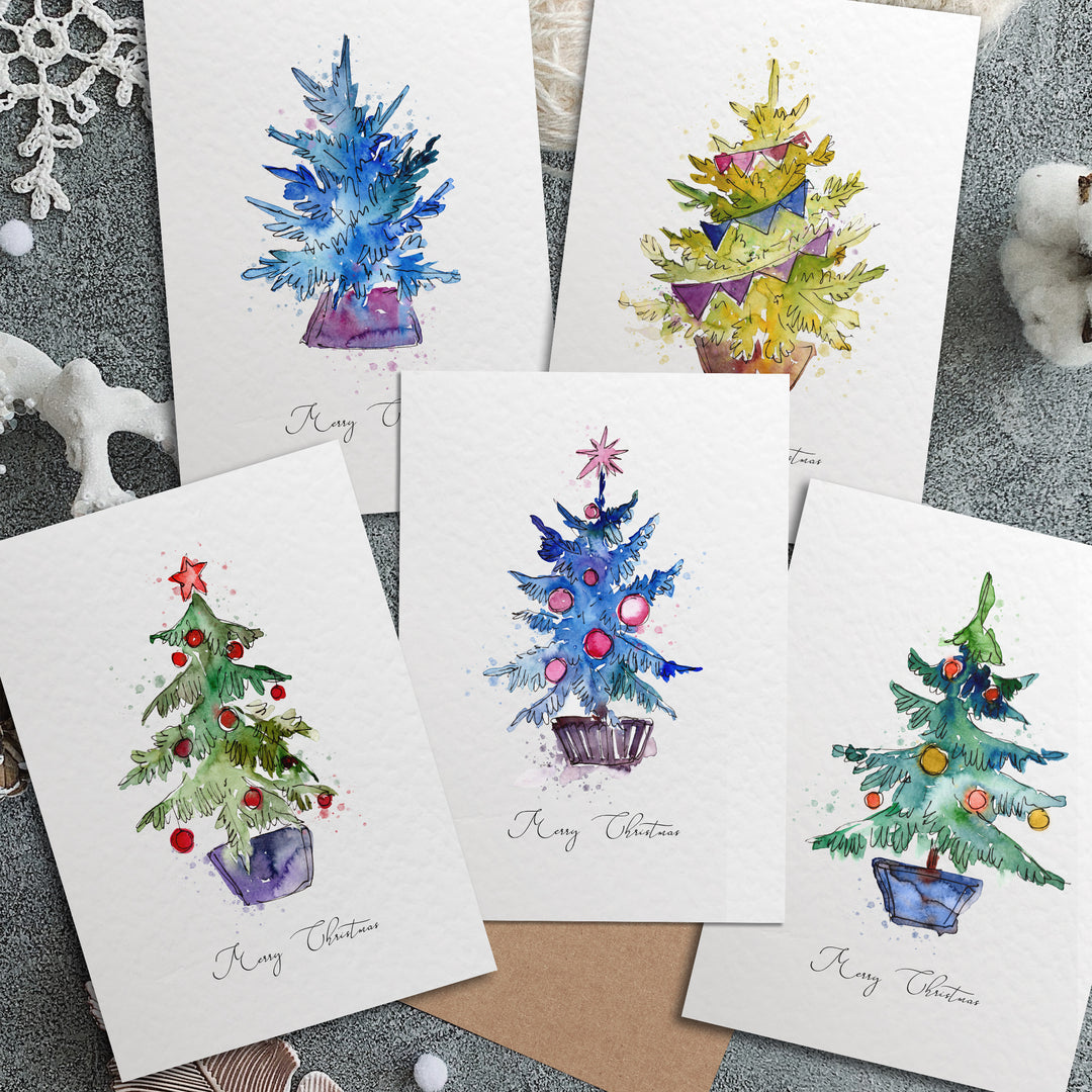 four christmas cards with watercolor christmas trees on them