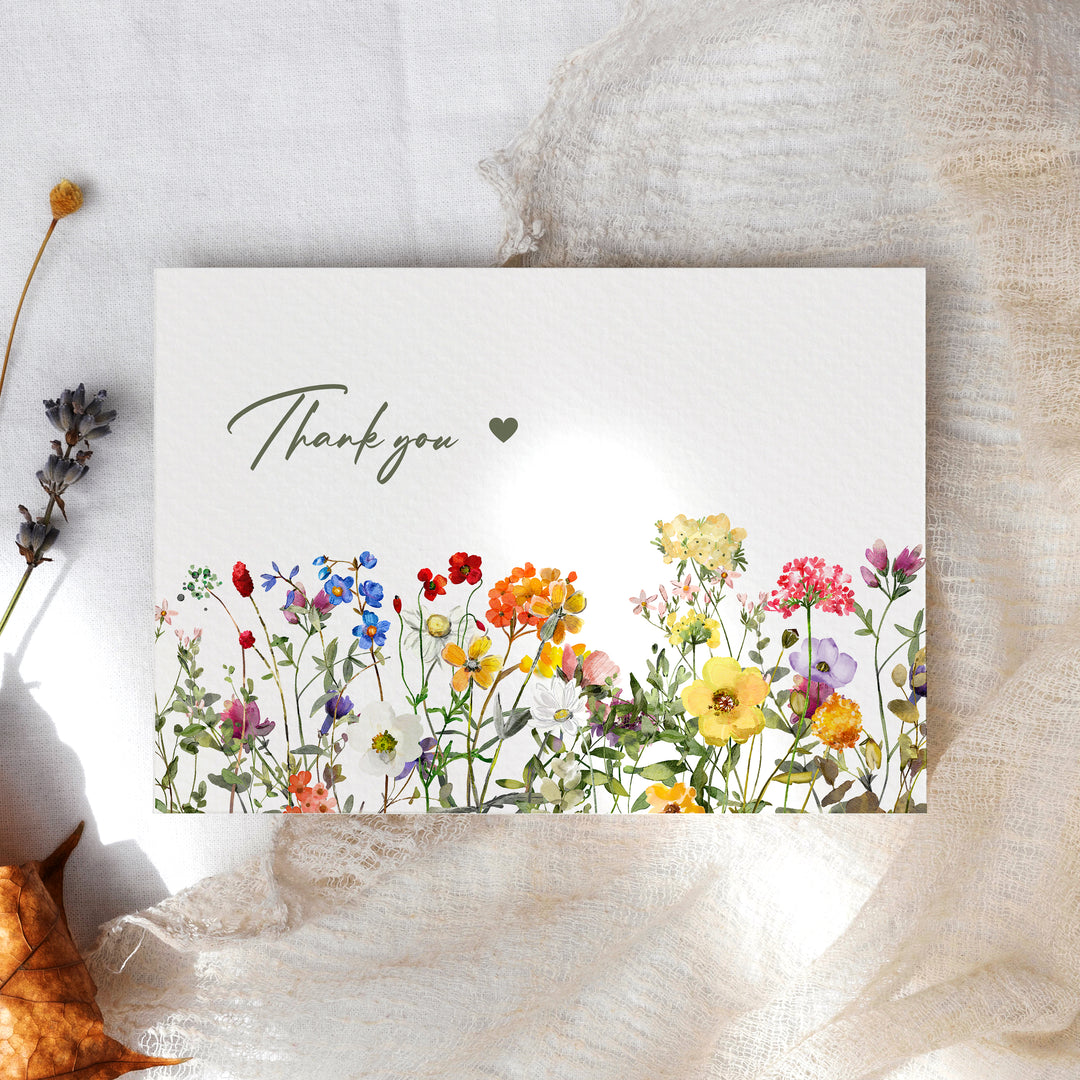 a thank card with a watercolor painting of flowers