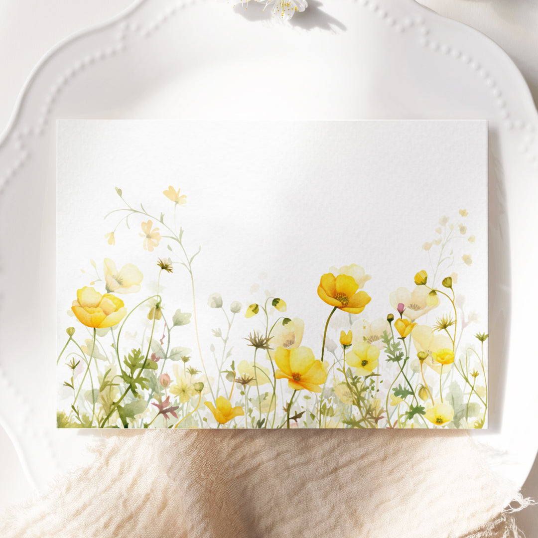 a white plate topped with a card with yellow flowers