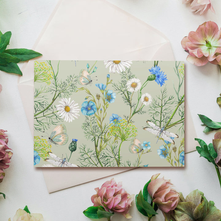 a card with flowers and a butterfly on it