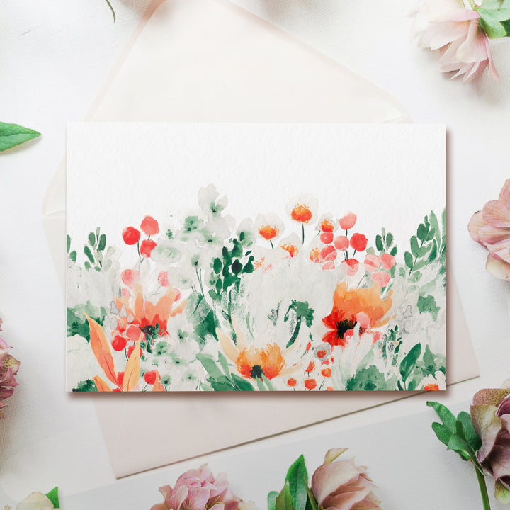 a card with watercolor flowers on it