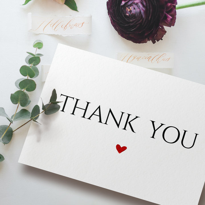 a thank you card sitting on top of a table