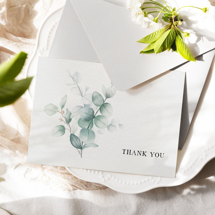 a thank you card with a flower on it