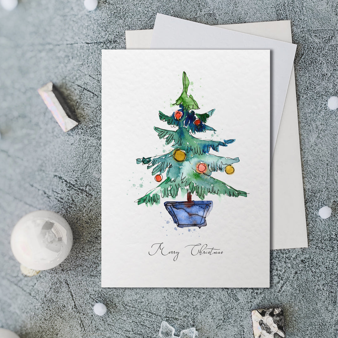 a card with a watercolor christmas tree on it