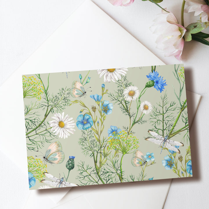 a card with flowers and butterflies on it