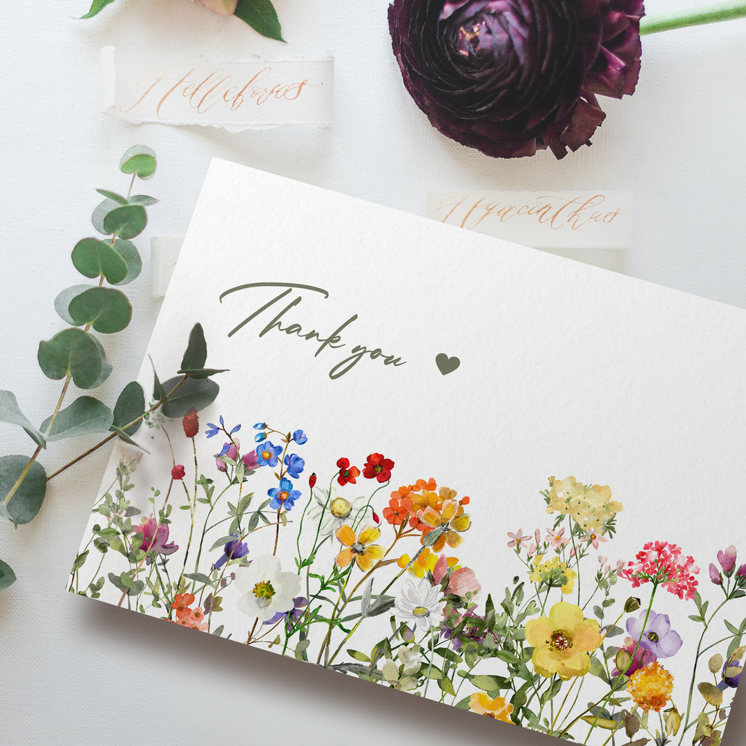 a thank you card with flowers on it