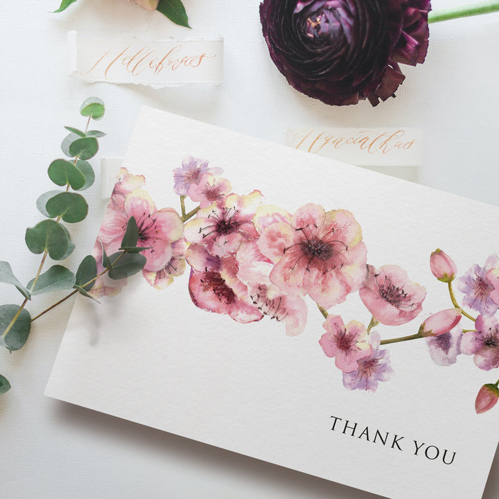 a thank you card with pink flowers and greenery