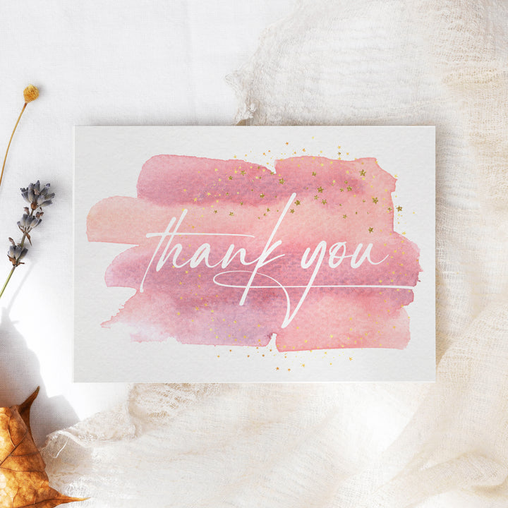 a thank you card with a pink watercolor stroke